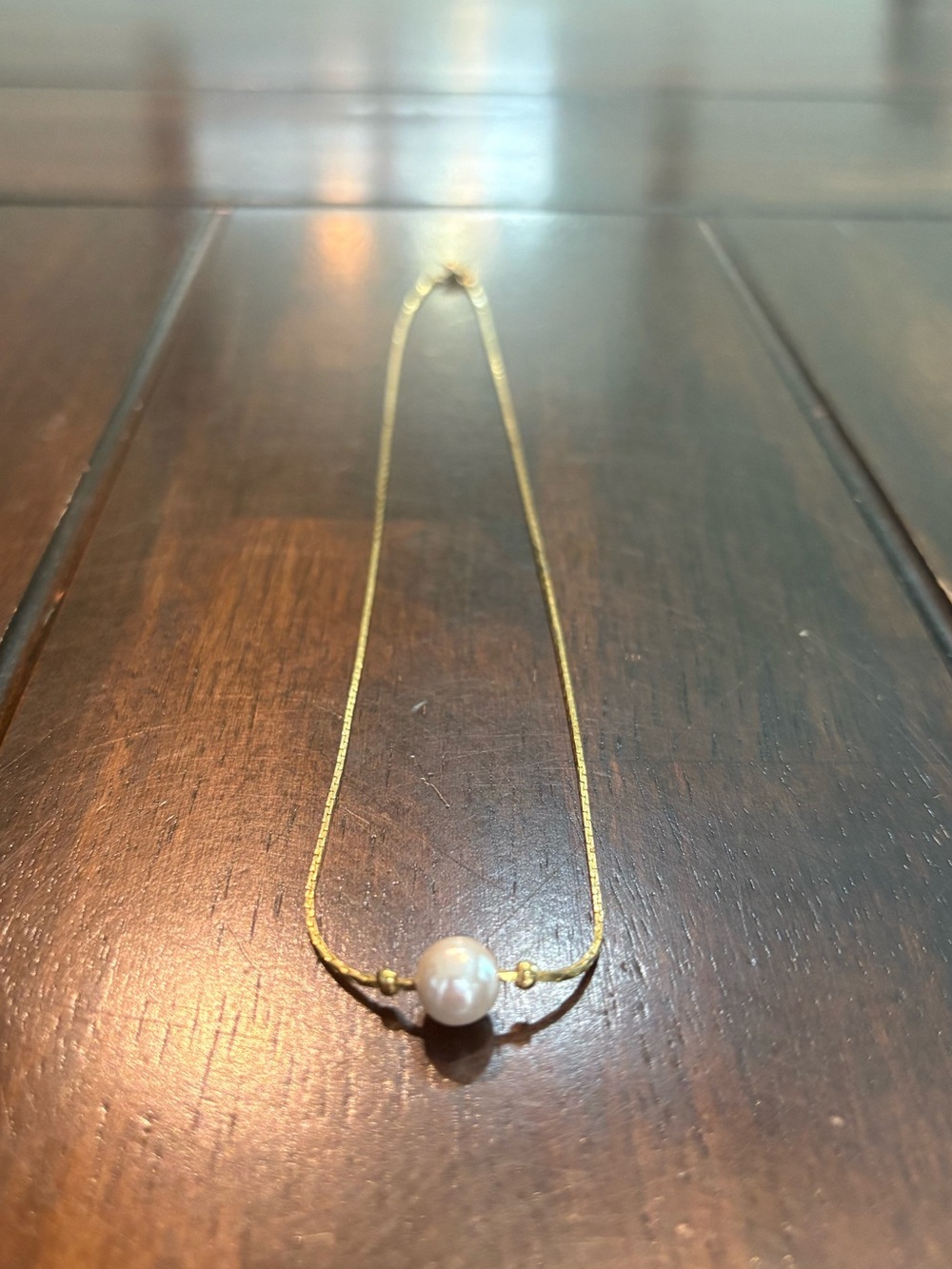 Gold chain necklace with white pearl pendant